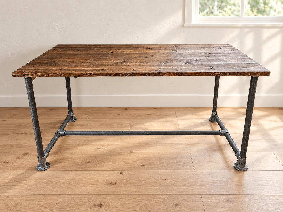 Ashwood reclaimed wood home office desk with dark plank tabletop and scaffold-pipe legs in a Scandinavian room.