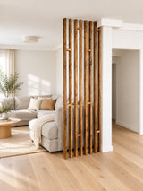 Benjamin reclaimed wood room divider with slim vertical slats and staggered shelves beside a cream sofa in a Scandinavian living room.