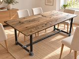 Bitterne reclaimed wood dining table with scaffold-pipe legs and a low metal stretcher in a warm Scandinavian dining room.