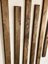 Chichester reclaimed wood wall slats with staggered lengths and natural weathered grain against a warm neutral wall.
