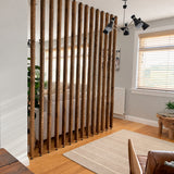 Georgina reclaimed wood room divider in Jacobean Dark Oak with floor-to-ceiling slats and adjustable pressure-fit feet.