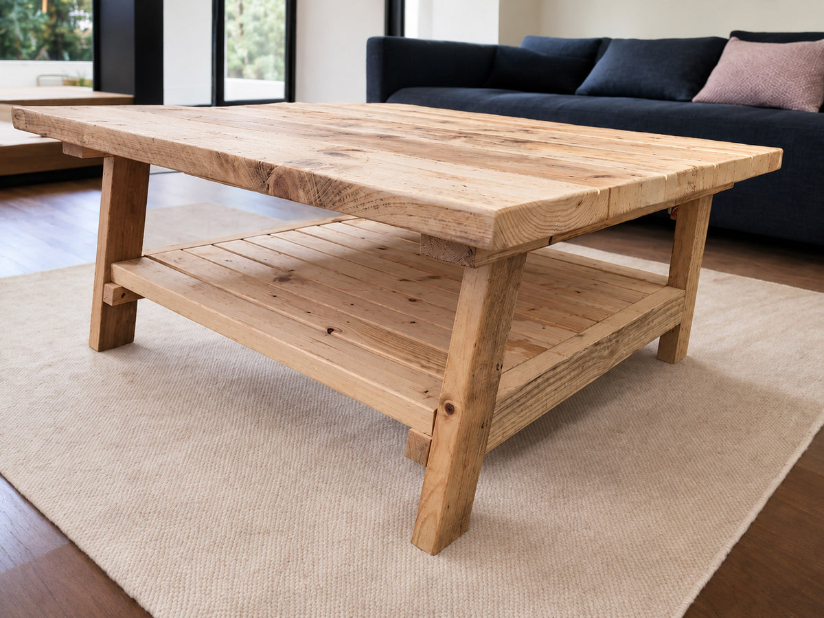 Side view of the Malmo reclaimed wood coffee table showing its lower storage shelf and angled wooden legs.