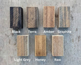 Seven Osmo wood-finish samples labelled Black, Terra, Amber, Graphite, Light Grey, Honey and Raw.