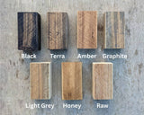 Seven Osmo wood-finish samples labelled Black, Terra, Amber, Graphite, Light Grey, Honey and Raw.