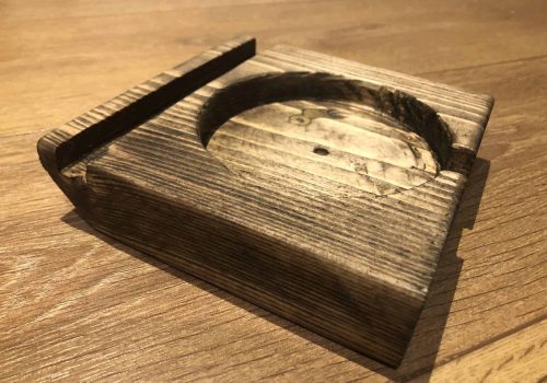 Mug holder fitted to a gaming table.
