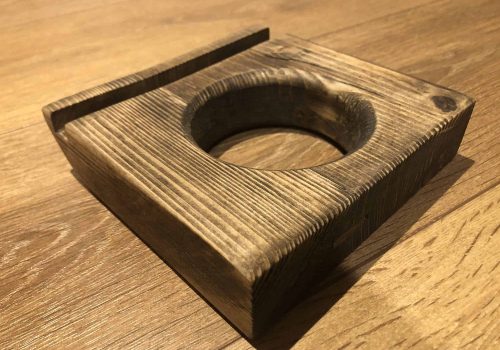 Dice holder fitted to a gaming table.