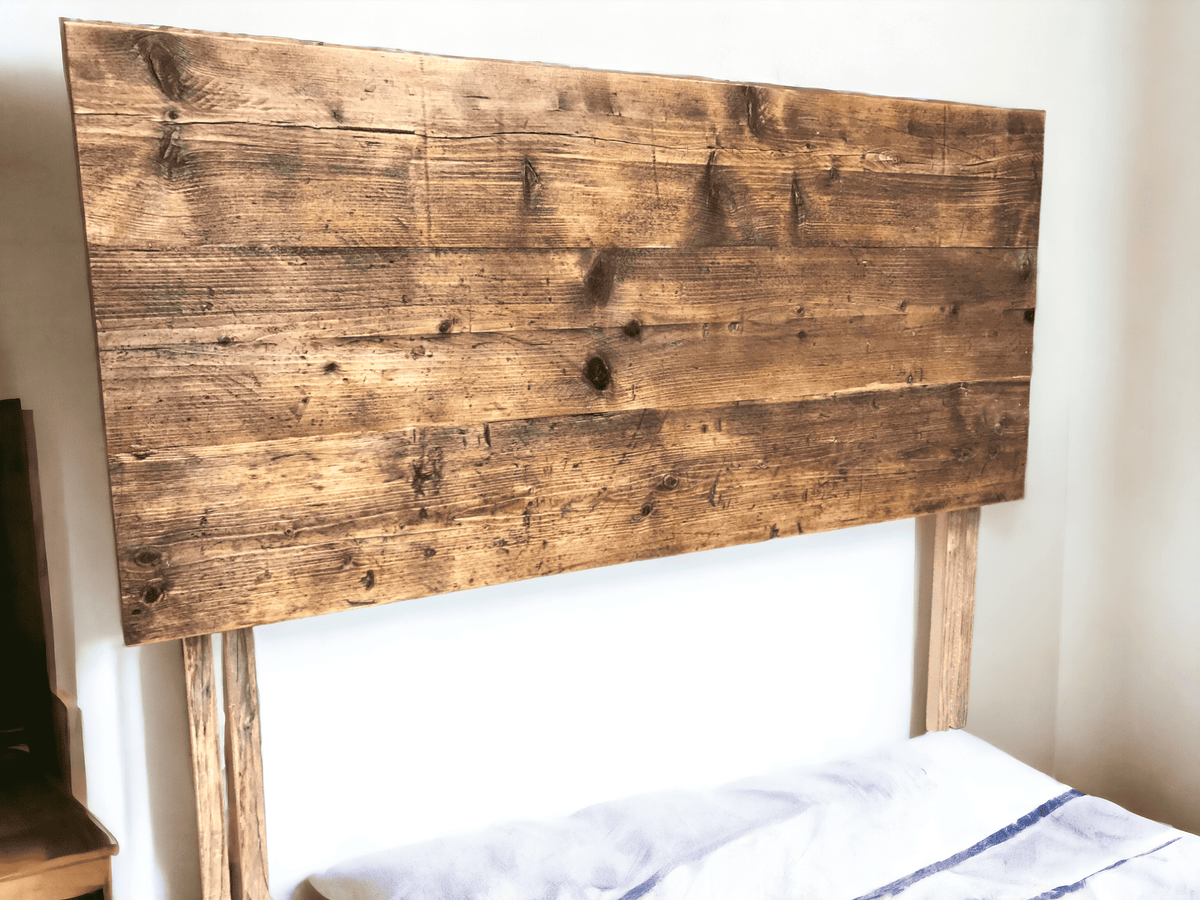 Reclaimed wood divan headboard fitted behind a bed.