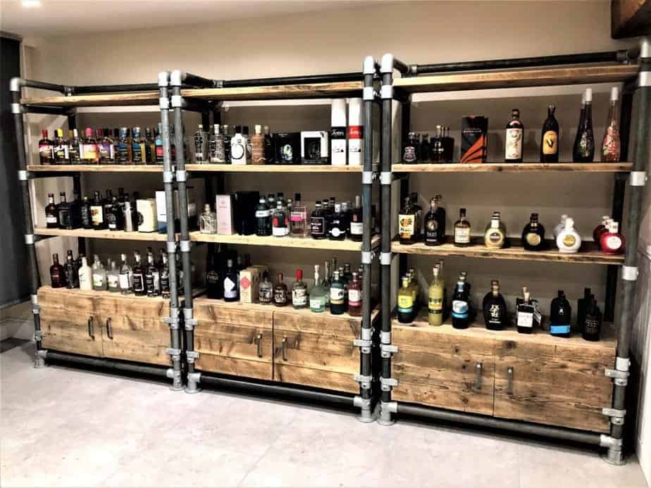 Reclaimed-wood shelving units with integrated cupboards in a shop