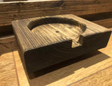 Dark-stained wooden game-table mug holder with a circular opening and front access notch.