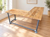 Silverdale L-shaped reclaimed wood corner desk with scaffold-pipe legs and round floor plates in a bright Scandinavian home office.