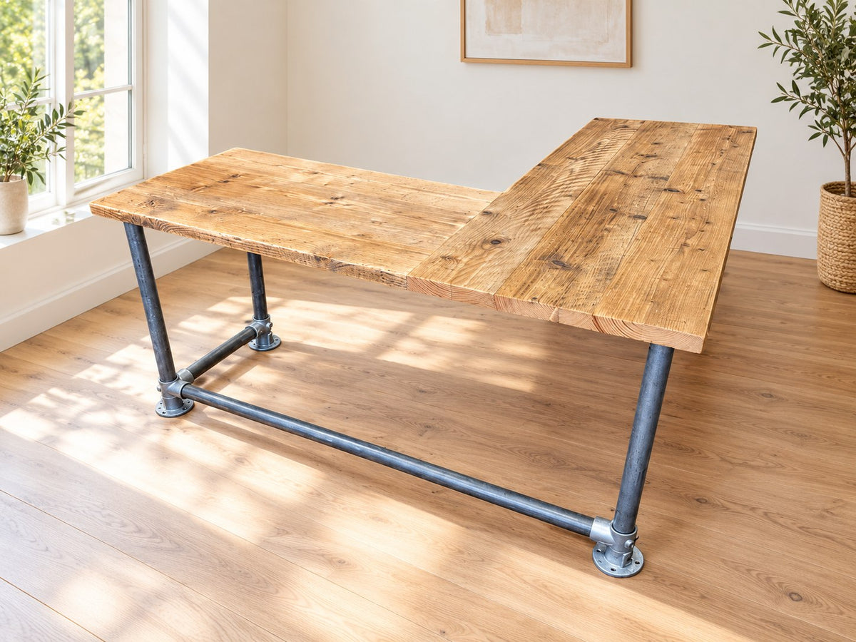 Silverdale L-shaped reclaimed wood corner desk with scaffold-pipe legs and round floor plates in a bright Scandinavian home office.